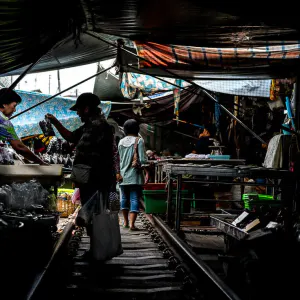 Woman buying in Mae Klong Railway Market