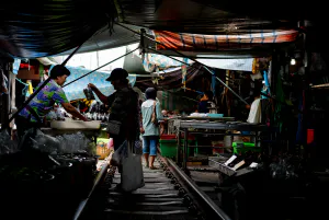 Woman buying in Mae Klong Railway Market