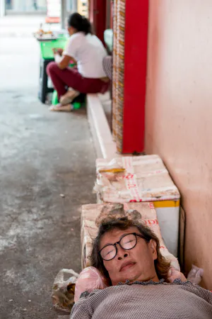 Woman taking a nap in passage