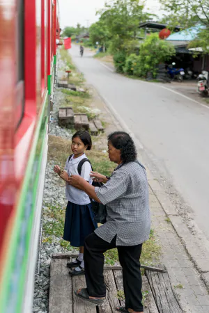 Girl and older woman getting on train