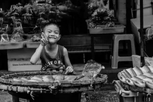 Boy selling dried fishes