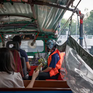 Woman holding handgrip on water-bus