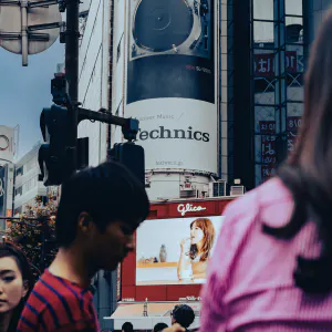 Electronic signboard on other side of pedestrians