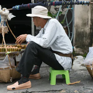 Street vendor doing business with carrying pole