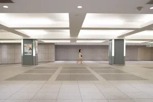 Woman walking spacious passage alone