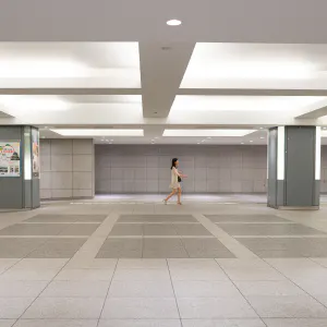 Woman walking spacious passage alone