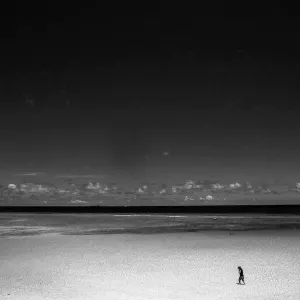 Lonely figure in shallow water