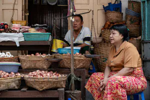 Man and woman selling onions and garlic