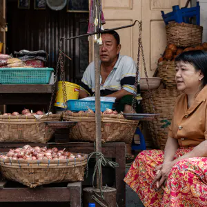 Man and woman selling onions and garlic