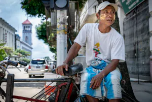 Pedicab driver waiting for customers in a street corner