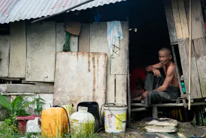 Man sitting in shanty house