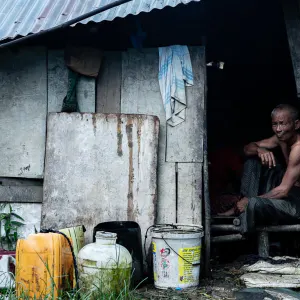Man sitting in shanty house