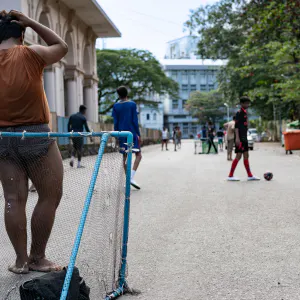 Young men playing football in downtown