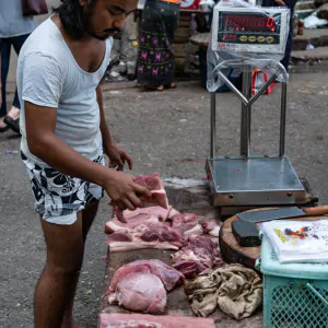 Man selling blocks of meat