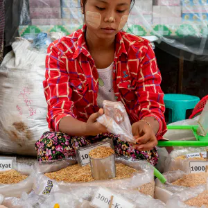Young woman selling dried shrimps