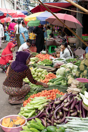 Woman with a hijab buying in greengrocery