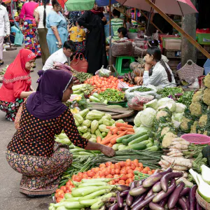 Woman with a hijab buying in greengrocery