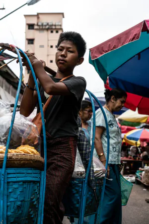 Young man carrying blue baskets