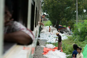 Many plastic bags beside rail track