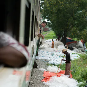 Many plastic bags beside rail track
