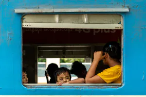 Parent and kids waiting for departure on train