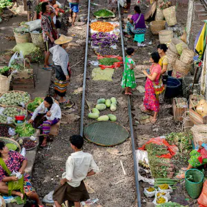 Vendors doing business along the railway track in the station yard