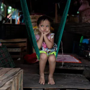 Little girl sitting on hammock