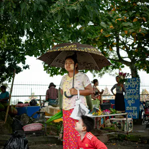 Woman putting un umbrella up