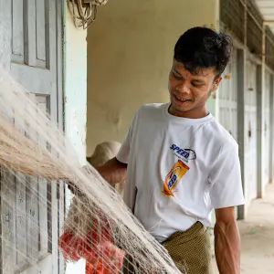 Man checking for doneness of fishnet