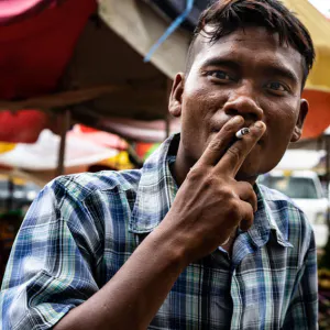 Man gazing while smoking cigarette
