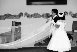 Kids holding hemline of wedding dress