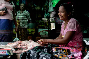Chickens seller giving a bitter laugh