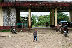 Boy walking alone in front of railway station