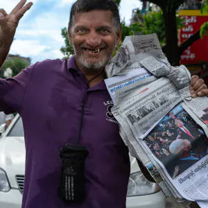 Man selling newspapers on the street