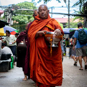 Buddhist monks carrying an alms bowl