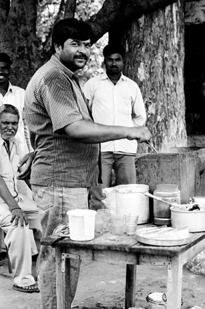 Man in chai stand