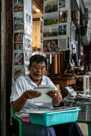 Man selling postcards