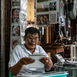 Man selling postcards
