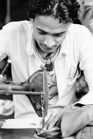 Young man sewing
