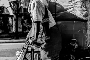 Man carrying big burdens by bicycle