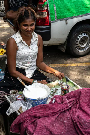 Woman selling Kun by roadside