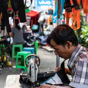 Man working with sewing machine