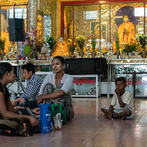 Local people relaxing in front of Buddha statues