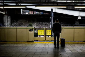 Businessman waiting for the train with his head down