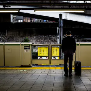 Businessman waiting for the train with his head down