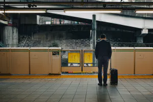 Businessman waiting for the train with his head down