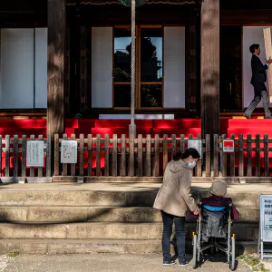 Worshippers praying in front of main hall called Konpon-Chudo