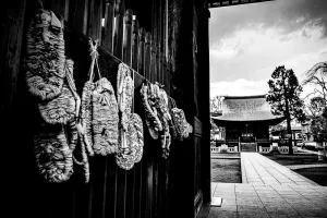 Straw sandals hung on wall in Buddhist temple