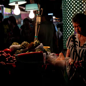 Older woman selling fruits in Linjiang Night Market