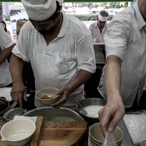 Men working in small busy kitchen